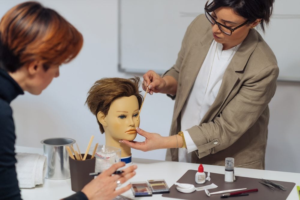 Cosmetic tattoo machine, pigments and tools laid out in the training studio