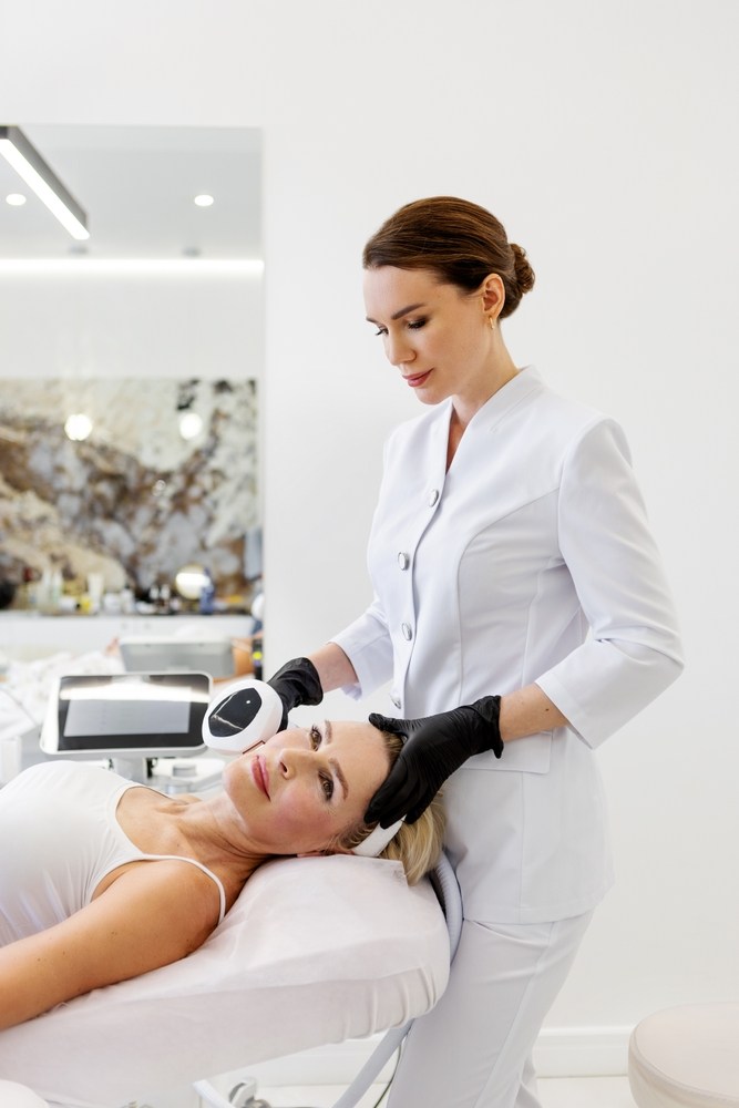 Skin therapist treating a relaxed client